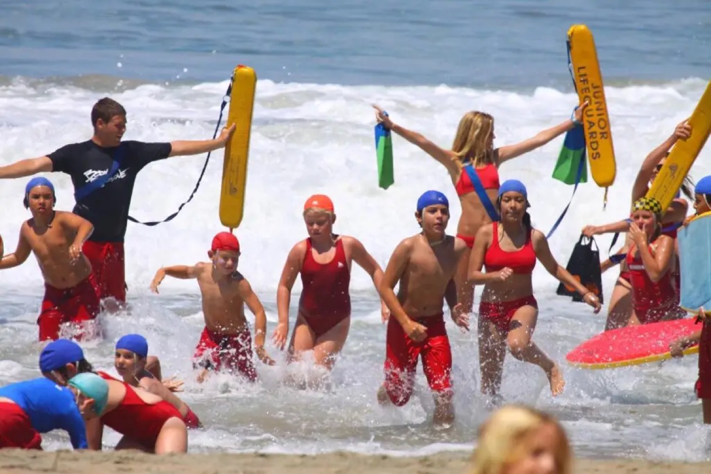 Junior Lifeguards running into the ocean